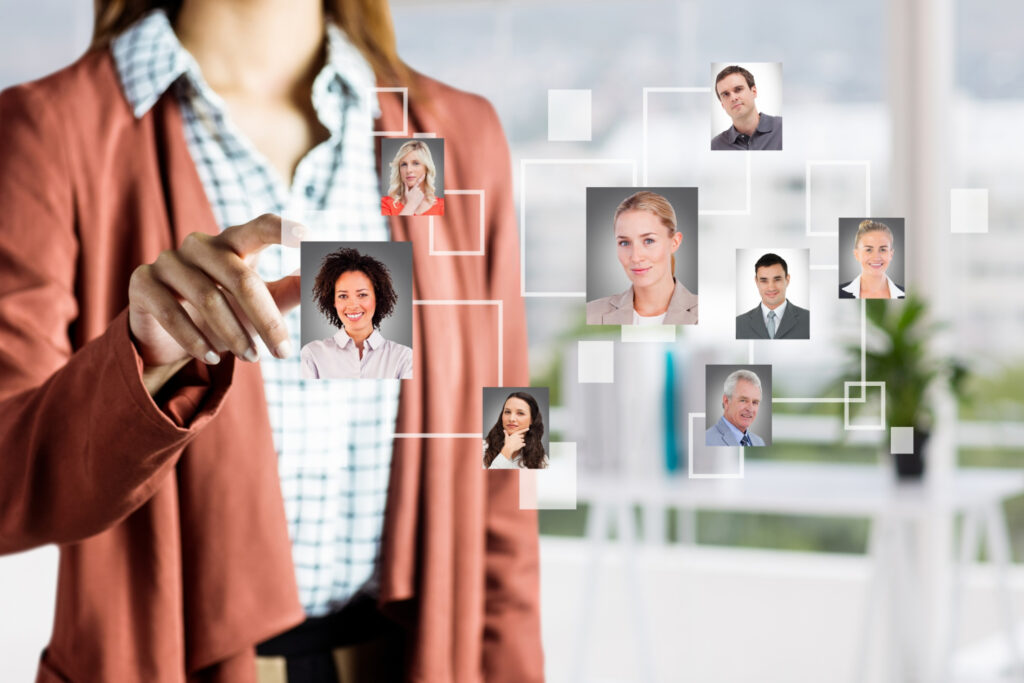 A woman in a suit and tie is looking at a picture